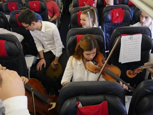 Spectacol INEDIT! De Ziua Internaţională a Muzicii, opt studenţi români au susţinut concerte simfonice în cursa Cluj Napoca - Londra şi retur (VIDEO)