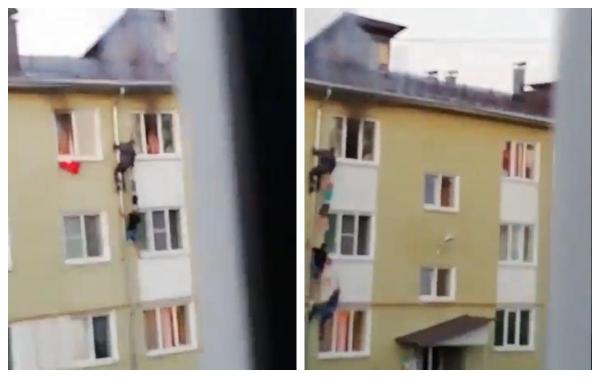 Gest impresionant: Copii scoşi dintr-un apartament în flăcări de vecinii care au făcut un lanţ uman, în Rusia