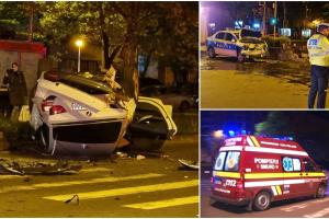 BMW făcut praf de mașina poliției, într-o intersecție din București. Bolidul a distrus bordurile și stâlpii, apoi s-a răsturnat