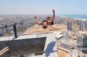 VIDEO-ȘOCANT! Un tânăr execută elemente de gimnastică pe marginea unei clădiri de 150 de metri înălțime!