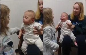 Bebelus în hohote de râs, după ce și-a auzit pentru prima oară surioara