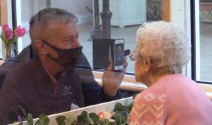 Momentul emoţionant când o bătrână de 92 de ani îşi vede fiul printr-o fereastră, din cauza restricţiilor, la un cămin de îngrijire