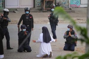 O călugăriță s-a așezat în genunchi în fața polițiștilor, la un protest din Myanmar. Doi oameni au murit la picioarele ei