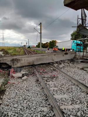 O grindă de zeci de tone dintr-un pod aflat în renovare s-a prăbușit peste o magistrală CFR, în Brașov. Un tren a apucat să oprească la 100 de metri de bucata de beton