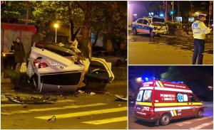 BMW făcut praf de mașina poliției, într-o intersecție din București. Bolidul a distrus bordurile și stâlpii, apoi s-a răsturnat