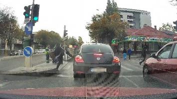 Scandal în traficul din Bucureşti. Pieton, filmat cum loveşte cu piciorul o maşină şi scuipă şoferul