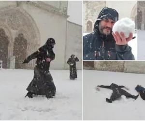 Dragi frați și surori, a sosit sora zăpadă. Călugări surprinși jucându-se cu bulgări și distrându-se în fața Bazilicii Sfântul Francisc din Assisi, în Italia